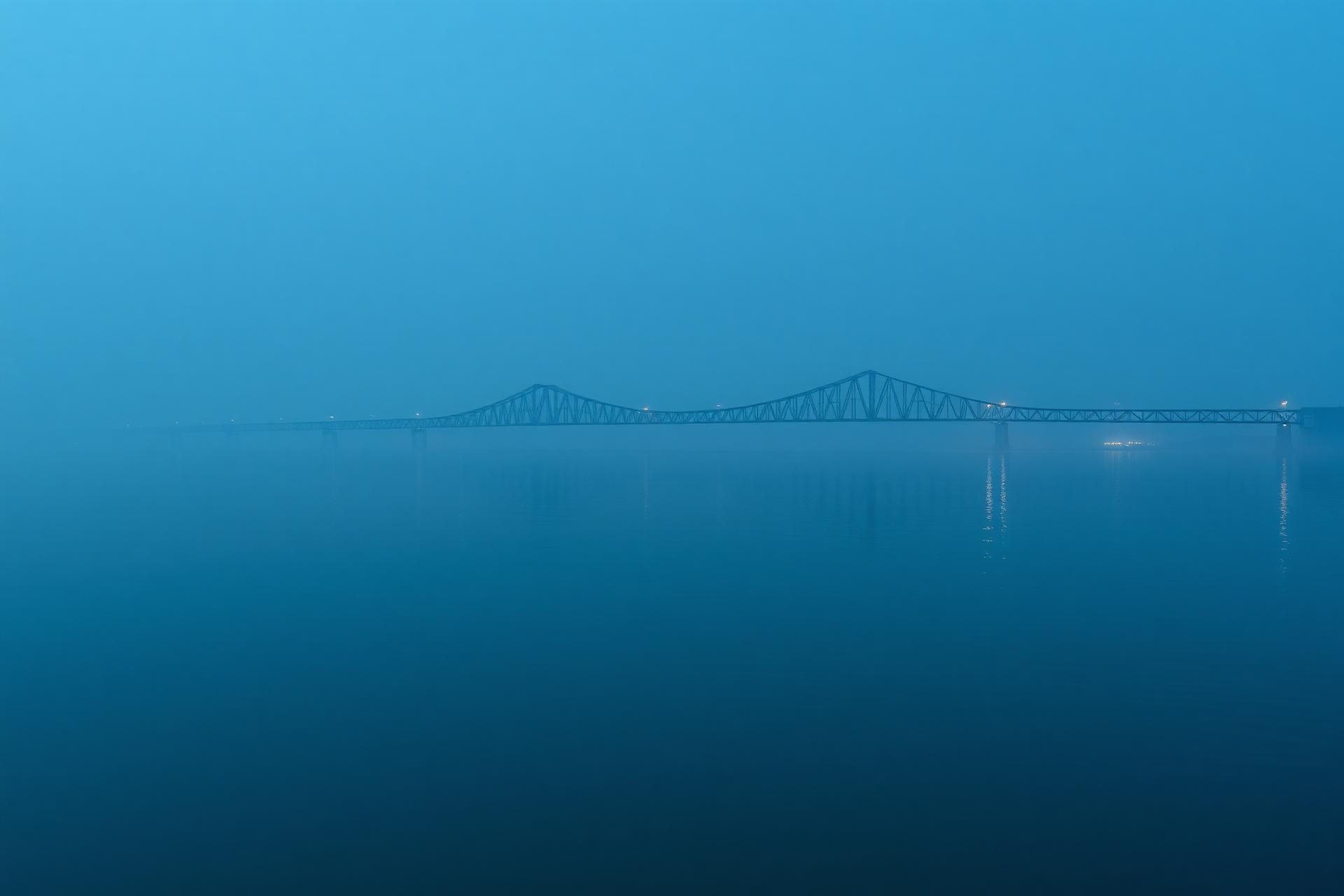 Foggy lakeshore bridge over Lake Michigan at blue hour